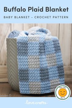 a crocheted blanket sitting on top of a wooden floor next to a box