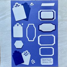 some cut outs are sitting on top of a piece of blue paper with white shapes