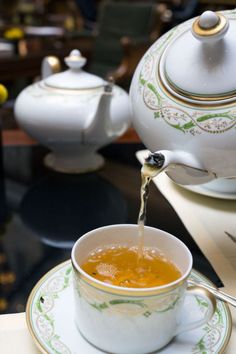 tea being poured into a cup on a saucer