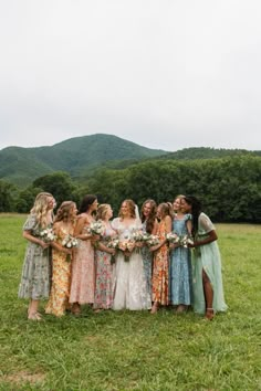 a group of women standing next to each other in a field