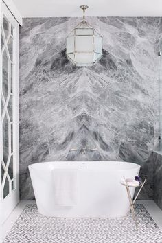 a white bath tub sitting next to a walk in shower