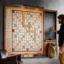 a man standing in front of a scrabble board