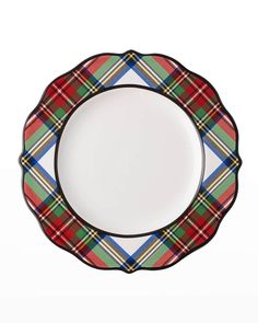 a red and green plaid plate with black trim on the rim, sitting in front of a white background