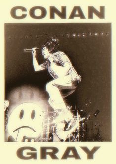 a black and white photo of a man on stage with the words gray written below him