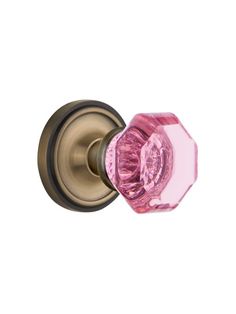 a pink glass door knob on a white background