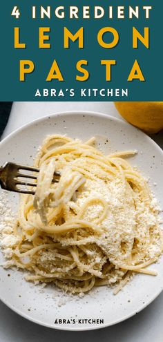 a white plate topped with pasta covered in parmesan cheese and lemon zest