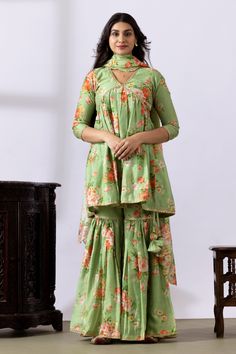 Pista green gathered kurta with floral digital prints and lace detailing. Paired with printed gharara and dupatta.
Components: 3
Pattern: Printed
Type Of Work: Floral
Neckline: V neck
Sleeve Type: Three quarter
Fabric: Chanderi
Color: Green
Other Details: 
Lace detailing
Tassel tie-up
Tassel detailing on edge of dupatta
Scallop border
Occasion: Puja - Aza Fashions Pista Green, Scallop Border, Types Of Work, Set For Women, Anarkali, Aza Fashion, Sleeve Type, Three Quarter, Types Of Sleeves