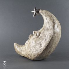 a sculpture of a half moon with a star on it