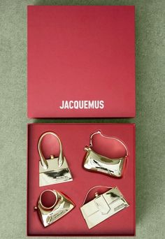 four pieces of silver and pink leather in a red box with the name jacquemus on it