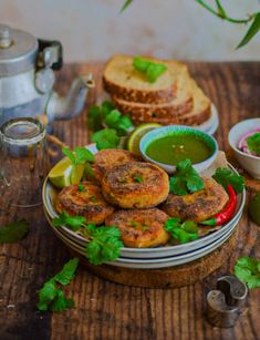 some food is sitting on a plate with green sauce