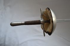 a close up of a metal object with a wooden handle