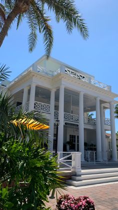 a large white building with columns on the front and stairs leading up to it's second floor