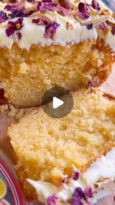 a piece of cake with white frosting and purple flowers