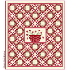 a red and white quilt with an image of a vase on the center, surrounded by squares