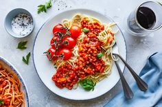 a plate of spaghetti with tomato sauce and basil