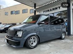 a gray van parked in front of a building