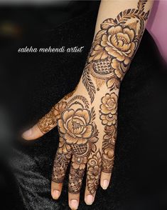 a woman's hand with henna tattoos on it and the words saabha mehndi artist