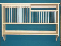 a white shelf sitting on top of a blue wall