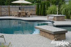 a backyard with a pool and patio furniture