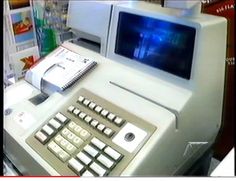 a machine that is sitting on top of a table with a keyboard and mouse in front of it