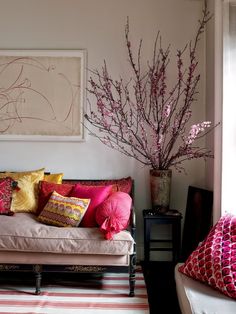 a living room filled with furniture and colorful pillows