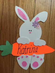 a paper cut out of a bunny holding a carrot with the word kartrina on it