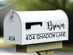 a white mailbox with the word brown on it's front and address written in black