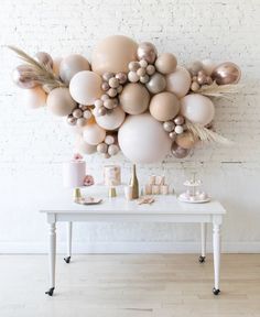 a white table topped with lots of balloons