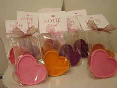 several heart shaped cookies in plastic bags on a table with tags attached to the top