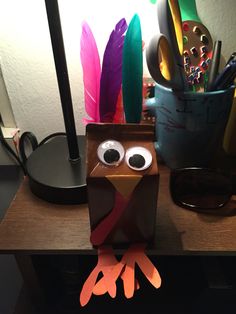 a paper turkey sitting on top of a desk