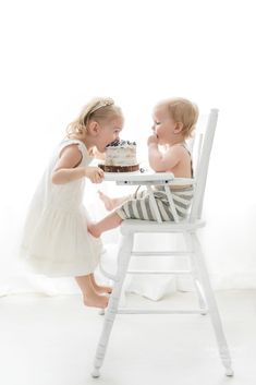 Baby in high chair cake smash with big sister taking a bite image by Reaj Roberts Photography, Phoenix baby photographer. Simple first birthday photos, cake smash photos, cake smash in highchair, cake smash with siblings, indoor sibling photos. Simple First Birthday, First Birthday Milestone, Cake Smash Pictures, Indoor Birthday, Milestone Photography, Family Cake, Birthday Highchair, Birthday Milestone, Lifestyle Photography Family