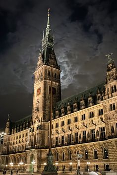 a large building with a clock tower at night