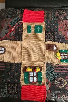 a crocheted christmas decoration on top of a couch