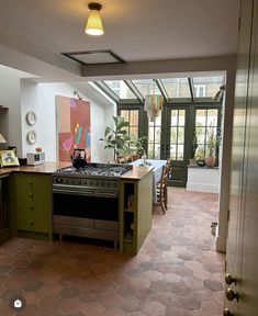 a kitchen with green cabinets and an oven