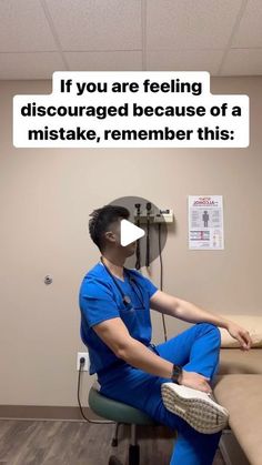 a man in scrubs sitting on a chair with his foot up to the wall