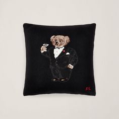 a black pillow with a dog in a tuxedo on it