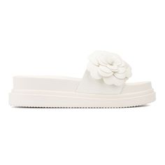 These slides feature a unique appeal with eye-catching flower appliqué that adds a touch of charm to your look. Not only are they visually striking, but they are also designed with comfort in mind, making them perfect for walking. The soft, cushioned sole ensures all-day wearability, while the floral details offer a playful and stylish twist. Whether you're heading to the beach or a casual outing, these slides blend fashion and function effortlessly. Platform Sandals White, Sandals White, Faux Leather Heels, New York And Company, Open Toe Shoes, Shoe Carnival, Jelly Sandals, Espadrille Sandals, Platform Wedge Sandals