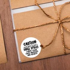 two brown envelopes tied up with twine and stickers saying warning everything is vegan in such as happiness