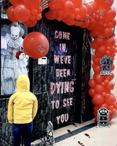 there is a child standing in front of a door with balloons attached to it and the words come in we've been dying to see you