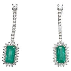 Elegant pair of earrings handmade in 18 kt gold. The two splendid natural emeralds with a vivid green color (emerald cut - total 1.60 ct) surrounded by 48 round brilliant-cut natural diamonds (VVS - G Color - 1.20 ct) stand out, the two diamonds at the height of the pin weigh approximately 0.08 ct each. 1970 circa. CONDITION: Pre-owned - Excellent METAL: 18k white Gold STONE: Diamond 1,20 TWC - VVS clarity, G/H color; Emerald TWC 1,60 MEASURES: Lenght 3,20 cm; width 0,80 cm WEIGHT: 4,10 grams *G Colombian Emeralds, Gold Stone, Natural Emerald, Emerald Diamond, G H, Emerald Cut, Round Brilliant, Earrings Handmade, Green Colors