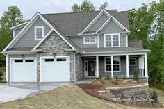 a house with two garages in the front and one on the back of it