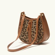 Upgrade Your Style with the Leopard Saddle Shoulder Bag Elevate your fashion game with our Leopard Saddle Shoulder Bag, crafted from premium microfiber leather for a luxurious feel. Designed for the modern woman, this bag combines functionality with trend-setting style, making it the perfect accessory for any occasion. Product Features Microfiber leather upper for durability and a sleek look Polyester lining material for added strength and resilience Zipper closure for secure storage of your essentials Bow decoration adds a touch of charm and femininity Spacious interior with an interior slot pocket for easy organization Available in classic Black or versatile Brown Benefits You'll Love Elevated Style: Stand out from the crowd with the chic leopard print design and sleek saddle shape of th