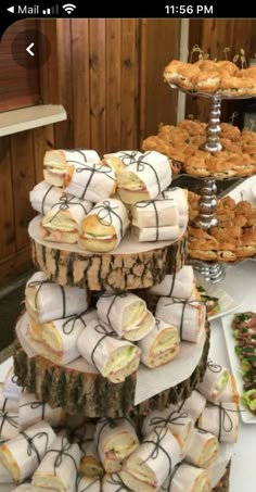 there are many sandwiches and pastries on the table at this wedding or bridal party