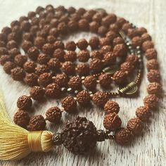 Hand made with 8mm Natural Rudraksha from India, 108 Mala for Japa Meditation. Wearing rudraksha seeds is believed to bring eternal blessings and is deemed closest to Lord Shiva himself.  The Rudraksha is believed to be Lord Shiva's tears which has the power to end sorrows and heal ailments. Hindus have been using rudraksha seeds in malas for thousands of years for meditation and prayer,  creating a sacred connection between mind, body and soul. Note that healing crystal meanings are spiritual supports to healing and are not prescriptions or healthcare information. Handmade Mala For Meditation And Diwali, Handmade Mala For Diwali Meditation, Handmade Bohemian Mala For Diwali, Bohemian Handmade Mala For Diwali, Spiritual Beaded Mala For Diwali, Festive Spiritual Beaded Necklaces, Festive Spiritual Beaded Mala, Ritual Mala With Latkans And Round Beads, Healing Crystals Meanings