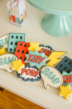 some decorated cookies are sitting on a table