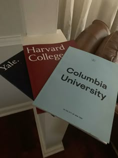 three books are stacked on top of each other