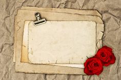 a piece of paper with two red roses on it and a clipboard attached to it