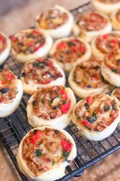 many small pastries are on a cooling rack