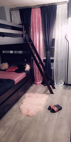 a bedroom with bunk beds and pink rugs on the floor next to a ladder