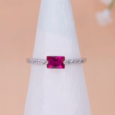 A bold horizontal magenta baguette cut cubic zirconia crystal on a gorgers dainty crystal ring band that can make perfect gift as promise ring, birthday gift or mothers day gift Color: Gold & Silver Ring size: 6,7,8 Material: Cubic Zirconia & 14k Gold plated or Silver plated on brass, topped off with clear coating for an extra layer of durability. 16mm diameter- size 617mm diameter- size 718mm diameter- size 8 Height: 1.5 mm Stone size 4x6 mm Baguette Cut Lab-created Ruby Ring As A Gift, Baguette Cut Lab-created Ruby Ring Gift, Pink Baguette Cut Ring For Gift, Baguette Cut Cubic Zirconia Crystal Ring As Gift, Cubic Zirconia Crystal Ring With Baguette Cut, Rectangular Stone Birthstone Ring With Prong Setting, Cubic Zirconia Crystal Ring Baguette Cut Gift, Cubic Zirconia Crystal Ring With Baguette Cut As Gift, Pink Gemstone Ring